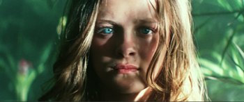 Movie still from “Adoration” (2019), directed by Fabrice du Welz – A young girl with blue eyes; Extreme Close Up shot, Low angle