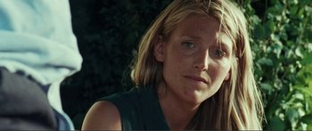 Movie still from “Adoration” (2019), directed by Fabrice du Welz – A person with long blonde hair; Close Up shot, Over the shoulder angle