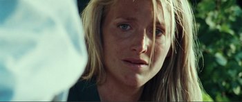 Movie still from “Adoration” (2019), directed by Fabrice du Welz – A person with long blonde hair; Close Up shot, Over the shoulder angle