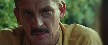 Movie still from “Adoration” (2019), directed by Fabrice du Welz – A man with a mustache; Close Up shot, Low angle