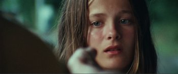 Movie still from “Adoration” (2019), directed by Fabrice du Welz – A person with a hand on their face; Close Up shot, Over the shoulder angle