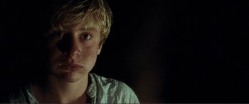 Movie still from “Adoration” (2019), directed by Fabrice du Welz – A young man with blonde hair stares into the camera; Close Up shot, Low angle