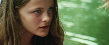 Movie still from “Adoration” (2019), directed by Fabrice du Welz – A person with long brown hair; Close Up shot, High angle