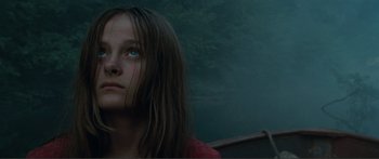 Movie still from “Adoration” (2019), directed by Fabrice du Welz – A young girl with blue eyes stares into the distance; Close Up shot, Low angle