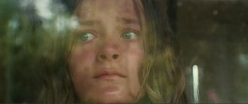 Movie still from “Adoration” (2019), directed by Fabrice du Welz – A child's face with green eyes; Extreme Close Up shot, Low angle