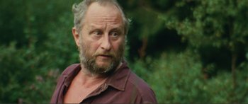 Movie still from “Adoration” (2019), directed by Fabrice du Welz – A person with a beard; Close Up shot, Over the shoulder angle