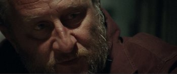 Movie still from “Adoration” (2019), directed by Fabrice du Welz – The face of a man with a long beard; Extreme Close Up shot, Low angle