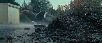 Movie still from “Adoration” (2019), directed by Fabrice du Welz – An overturned car on the side of the road; Wide shot, High angle