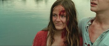Movie still from “Adoration” (2019), directed by Fabrice du Welz – A woman with blood all over her face and neck; Close Up shot, High angle
