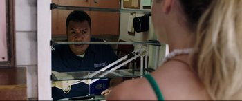 Movie still from “Adrift” (2018), directed by Baltasar Kormákur – A man holding a passport in front of a mirror; Medium shot, Over the shoulder angle