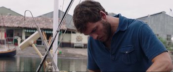 Movie still from “Adrift” (2018), directed by Baltasar Kormákur – A man in a blue shirt is on a boat; Close Up shot, Over the shoulder angle