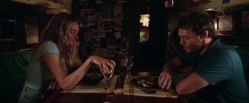 Movie still from “Adrift” (2018), directed by Baltasar Kormákur – Two people sitting at a table with a plate of food; Medium shot, Over the shoulder angle