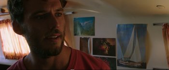 Movie still from “Adrift” (2018), directed by Baltasar Kormákur – A person in a red shirt in a room; Close Up shot, Over the shoulder angle