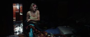Movie still from “Adrift” (2018), directed by Baltasar Kormákur – A woman sitting on the ground in a dark room; Medium shot, Overhead angle