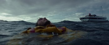 Movie still from “Adrift” (2018), directed by Baltasar Kormákur – A man floating in the ocean on a life raft; Close Up shot, Overhead angle