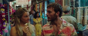 Movie still from “Adrift” (2018), directed by Baltasar Kormákur – A man and a woman are standing in a crowded market; Close Up shot, Over the shoulder angle