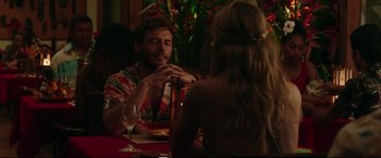 Movie still from “Adrift” (2018), directed by Baltasar Kormákur – A man and a woman sitting at a table with a bottle of wine; Medium shot, Over the shoulder angle