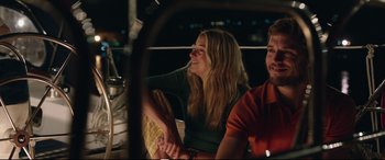 Movie still from “Adrift” (2018), directed by Baltasar Kormákur – A woman and a man sitting next to each other on a boat at night; Medium shot, Low angle