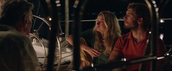 Movie still from “Adrift” (2018), directed by Baltasar Kormákur – A woman sitting next to another woman holding a drink; Medium shot, Low angle