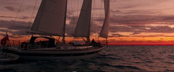 Movie still from “Adrift” (2018), directed by Baltasar Kormákur – A sailboat sailing on the ocean at sunset; Extreme Wide shot, Low angle