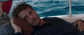 Movie still from “Adrift” (2018), directed by Baltasar Kormákur – A person laying on a bed near the ocean; Close Up shot, High angle