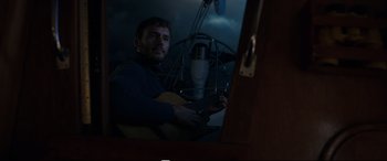 Movie still from “Adrift” (2018), directed by Baltasar Kormákur – A man sitting in front of a microphone holding a guitar; Medium shot, Low angle