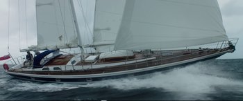 Movie still from “Adrift” (2018), directed by Baltasar Kormákur – A sailboat is sailing in the ocean on a cloudy day; Extreme Wide shot, High angle