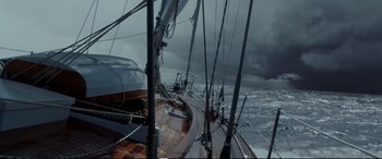 Movie still from “Adrift” (2018), directed by Baltasar Kormákur – A boat in the ocean under a cloudy sky; Extreme Wide shot, High angle