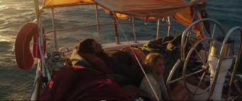 Movie still from “Adrift” (2018), directed by Baltasar Kormákur – A man and a woman laying on a sailboat in the ocean; Wide shot, High angle
