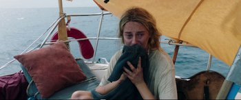 Movie still from “Adrift” (2018), directed by Baltasar Kormákur – A woman sitting on top of a sailboat with a towel over her face; Close Up shot, High angle