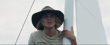 Movie still from “Adrift” (2018), directed by Baltasar Kormákur – A woman in a hat holding onto a white pole; Close Up shot, Low angle