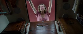 Movie still from “Adrift” (2018), directed by Baltasar Kormákur – A woman standing in front of an open door; Medium shot, Overhead angle