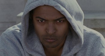 Movie still from “Adulthood” (2008), directed by Noel Clarke – A person wearing a hooded sweatshirt; Close Up shot, Low angle