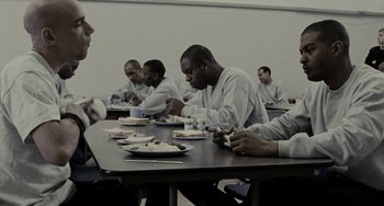 Movie still from “Adulthood” (2008), directed by Noel Clarke – A group of people sitting at a table eating food; Medium shot, High angle