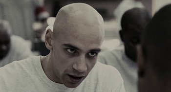 Movie still from “Adulthood” (2008), directed by Noel Clarke – A man with a bald head looking into the camera; Close Up shot, Low angle