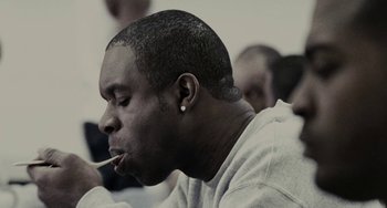 Movie still from “Adulthood” (2008), directed by Noel Clarke – A person smoking a cigarette; Close Up shot, Low angle