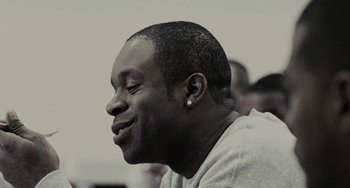 Movie still from “Adulthood” (2008), directed by Noel Clarke – A person with his eyes closed; Close Up shot, Over the shoulder angle