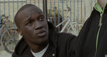 Movie still from “Adulthood” (2008), directed by Noel Clarke – A person wearing a black jacket; Close Up shot, Over the shoulder angle