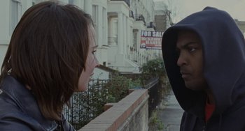 Movie still from “Adulthood” (2008), directed by Noel Clarke – A man and a woman talking in front of a building; Close Up shot, Over the shoulder angle