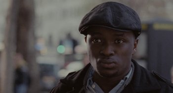Movie still from “Adulthood” (2008), directed by Noel Clarke – A person wearing a hat; Close Up shot, Low angle