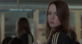 Movie still from “Adulthood” (2008), directed by Noel Clarke – A young woman with blue eyes is looking at the camera; Close Up shot, Over the shoulder angle