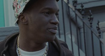 Movie still from “Adulthood” (2008), directed by Noel Clarke – A person wearing a hat; Close Up shot, Low angle