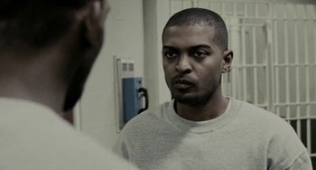 Movie still from “Adulthood” (2008), directed by Noel Clarke – A man looking at himself in the mirror in front of a mirror; Close Up shot, Over the shoulder angle
