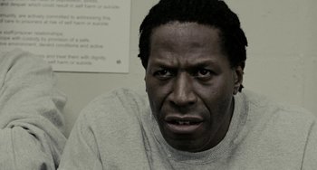 Movie still from “Adulthood” (2008), directed by Noel Clarke – A person wearing a sweater; Close Up shot, Low angle