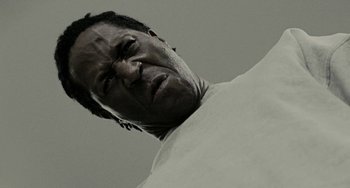 Movie still from “Adulthood” (2008), directed by Noel Clarke – A person looking up at the sky; Extreme Close Up shot, Low angle