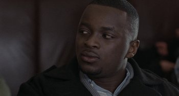 Movie still from “Adulthood” (2008), directed by Noel Clarke – A person wearing a jacket; Close Up shot, Over the shoulder angle