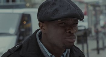 Movie still from “Adulthood” (2008), directed by Noel Clarke – A person wearing a hat; Close Up shot, Low angle