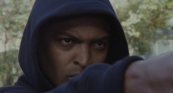 Movie still from “Adulthood” (2008), directed by Noel Clarke – A person wearing a hooded sweatshirt; Close Up shot, Low angle