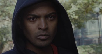 Movie still from “Adulthood” (2008), directed by Noel Clarke – A person wearing a hooded sweatshirt; Close Up shot, Low angle