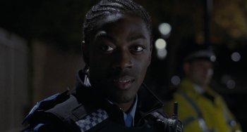 Movie still from “Adulthood” (2008), directed by Noel Clarke – A man in a police uniform is looking at the camera; Close Up shot, Low angle